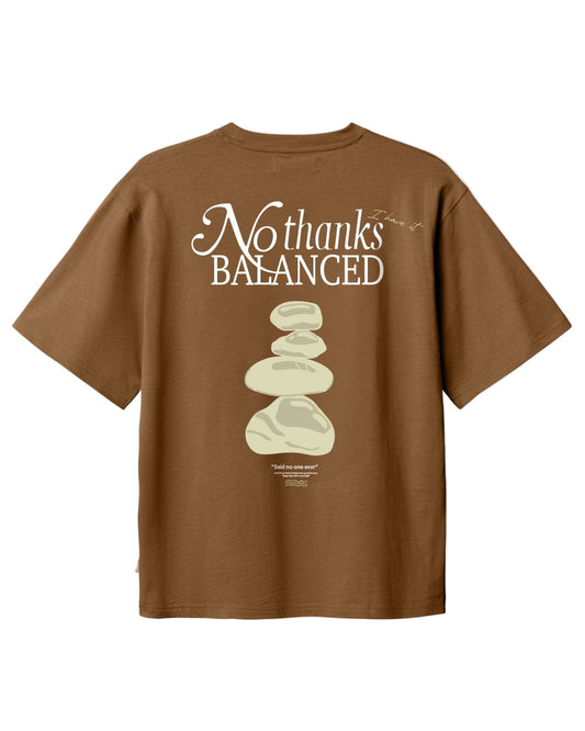 Brown t-shirt with 'No thanks BALANCED' text and stone design on a white background
