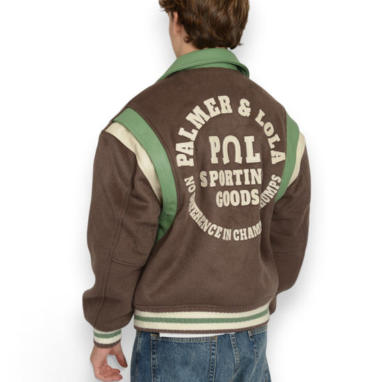 PAL Sporting Goods Ranch Varsity Jacket in Deep Mahogany, gedragen achteraanzicht met PAL-rugborduring boven een jeans.