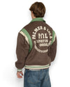 PAL Sporting Goods Ranch Varsity Jacket in Deep Mahogany, gedragen achteraanzicht met PAL-rugborduring boven een jeans.