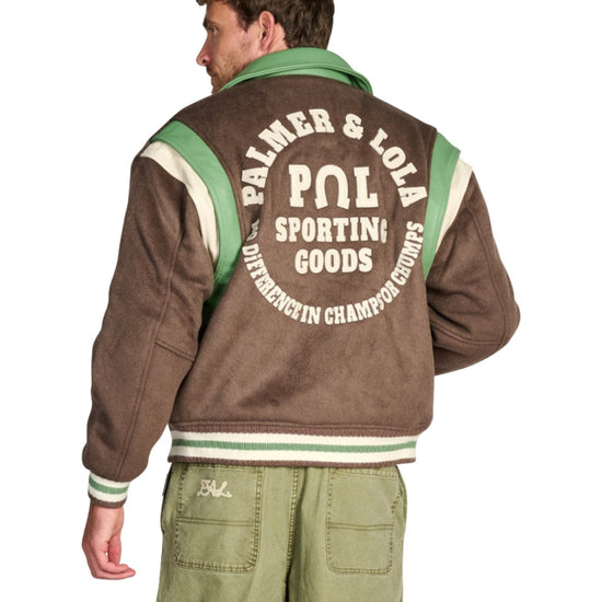 PAL Sporting Goods Ranch Varsity Jacket in Deep Mahogany, gedragen achteraanzicht met rugborduring en groene Gallop Barrel Leg broek.