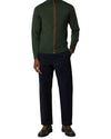 Paul Smith groene merino cardigan gedragen met een donkerblauwe broek en groene schoenen