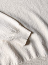 Roberto Collina Irregular Texture Skipper Polo in Soft Ecru
 detail van de stof bij checkpoint