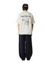 Achterkant van de Woodbird WBBaine Wok Tee Off White met grote “I don’t wok here” rugprint